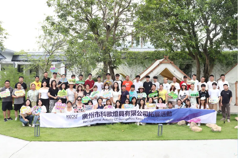 Specialized Roles - Group photo of all KEOU employees on lawn for corporate outdoor recreational activity