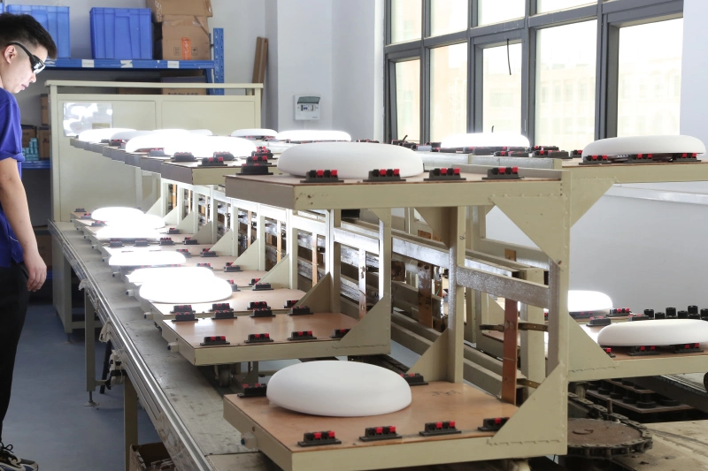 Testing Studio (1)Worker inspects LED panel lights on aging test line for factory quality control